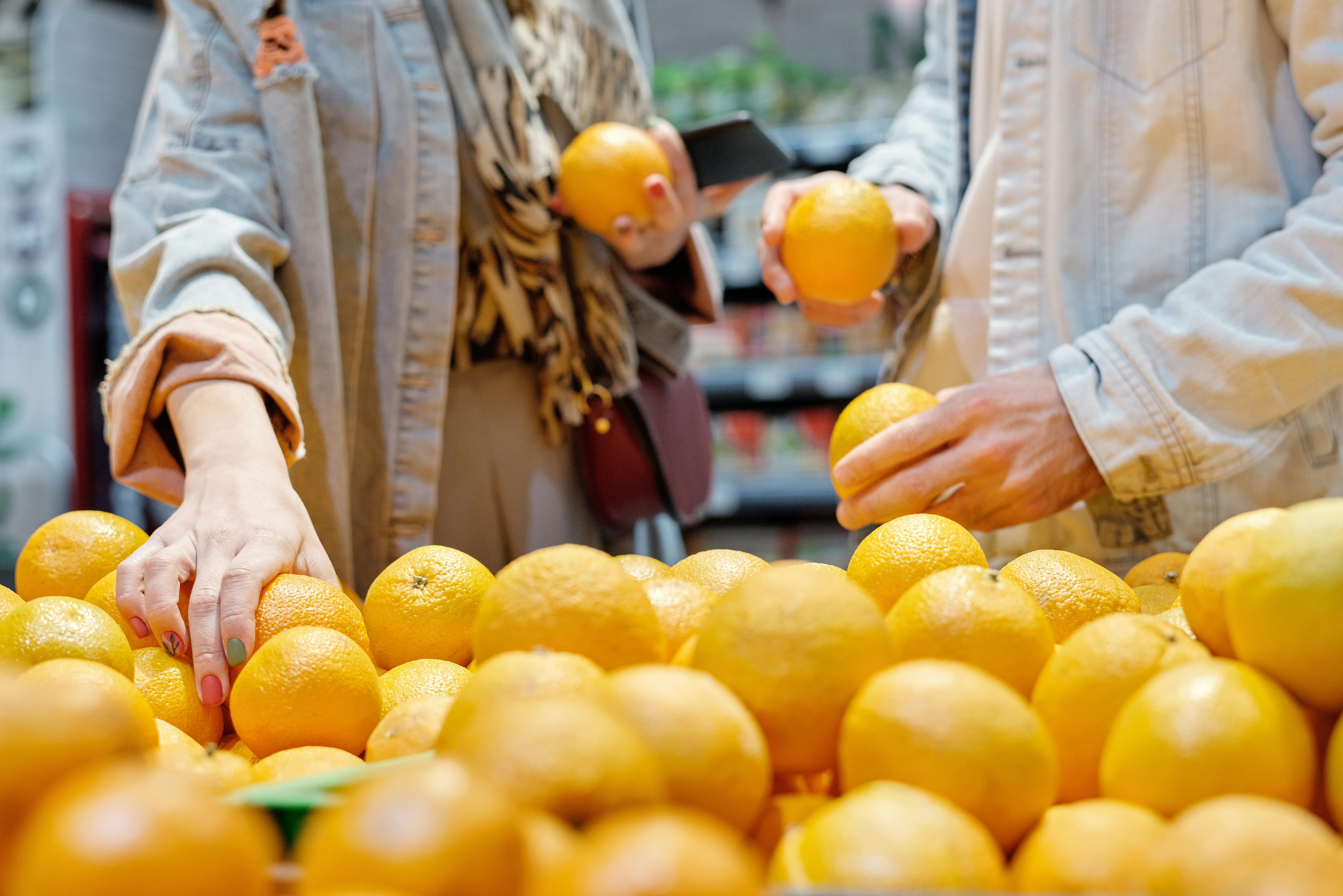 Hands sorting fresh oranges